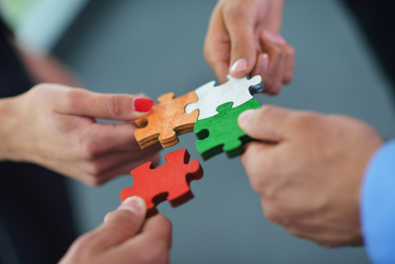 Team putting together a puzzle